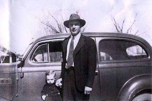 <dean and frank bass standing by old car>